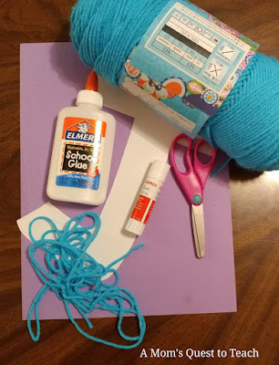 materials for craft: yarn, scissors, glue, glue stick, construction paper