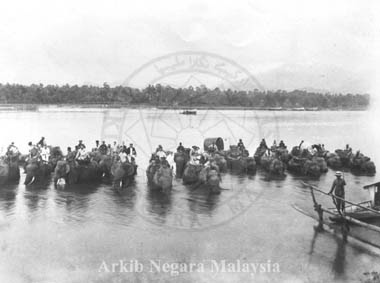 Fording the river near Kuala Kangsar on elephants. Probably taken during the Federal Conference ( 1st Durbar ) period in July 1897 and quite possibly this was when the party was on its way to 