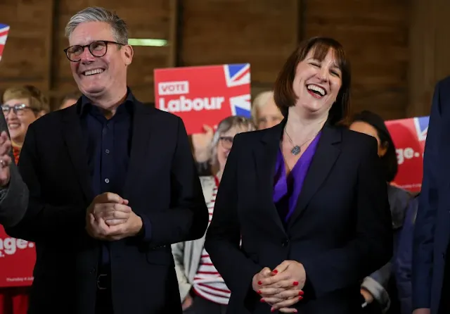British opposition Labour Party leader Keir Starmer and Shadow Chancellor of the Exchequer Rachel Reeves react during a campaign event at a farm in Oxfordshire