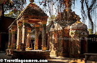 Recently I was at my hometown in Mandi, Himachal Pradesh and got to visit this wonderful place called Nawahi Devi with some ancient temples.This place has least visibility on web and feeling great to post about this wonderful hill station with ancient temples. Let's check out this Photo Journey to know more about this place and what more to expect...Here is a view of Shiva Temple around one of the corners in campus of Mata Nawahi Devi Temple. This portion of Nawahi Devi Temple looked most interesting to me and spend most of the time around the same. Nawahi Devi Temple has huge space and different temples dedicated to various gods including Luxmi-Narayan and Shiva.Just outside the main temple area, there is a huge water pond which was dry in the month of November. There is a beautiful temple in the middle of this water temple which is accessible through a bridge connected to main road. Imagine the time of year when this pond is full of water and we walk over the bridge to have a glimpse inside this colorful temple. Town having this temple is known as 'Nawahi Devi' and is quite lively place as compared to other towns around it. Nawahi Devi has various shops with pooja stuff, a governement schools and relevant shops with kids' stuff.There is a banyan tree in the campus of Nawahi Devi Temple. Married couples come to this place just after the marriage and then at the later stage to put wedding-bangles (chooda) and Sehra around it's branches.Here is a photographs of Nawahi Mata Statue placed inside the main temple with huge structure around it. Main temple of Nawahi devi is just in front of main gate and there is hardly any walk from road to the gate. It's just next to the main road with connects Sarkaghat with Jahu, which is part of Hamirpur District. Various people from distant places come to Nawahi Devi.Here is a photograph of top part of main temple in the campus of Nawahi Devi Temple