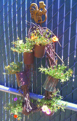 grapevine wreath with tin cans filled with portulaca