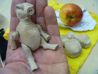 Small Wooden pig sitting in hand wants apple