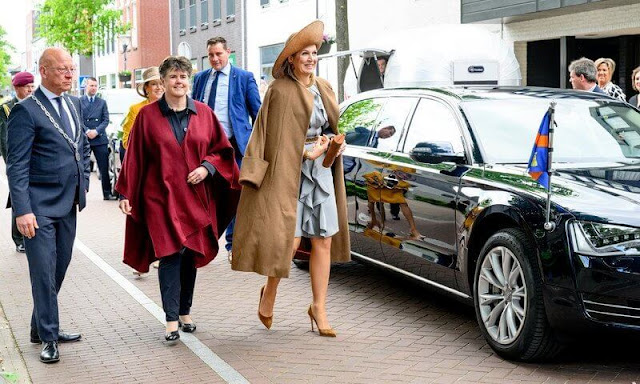 Queen Maxima wore a gray ruffled silk midi dress by Natan. Camel wool coat. Van Gogh lived in Nuenen