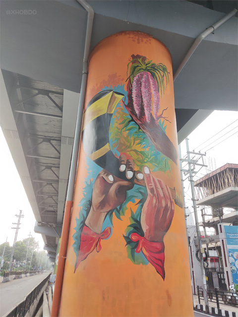 Assamese traditional pepa with Kopou Phool graffiti at Zoo Road Flyover