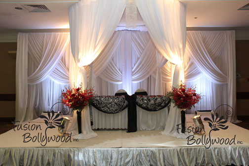 white draping gazebo with damask touch with red orchid arrangement 