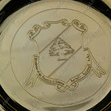 The presidential crest impressed on a gold plated plate.