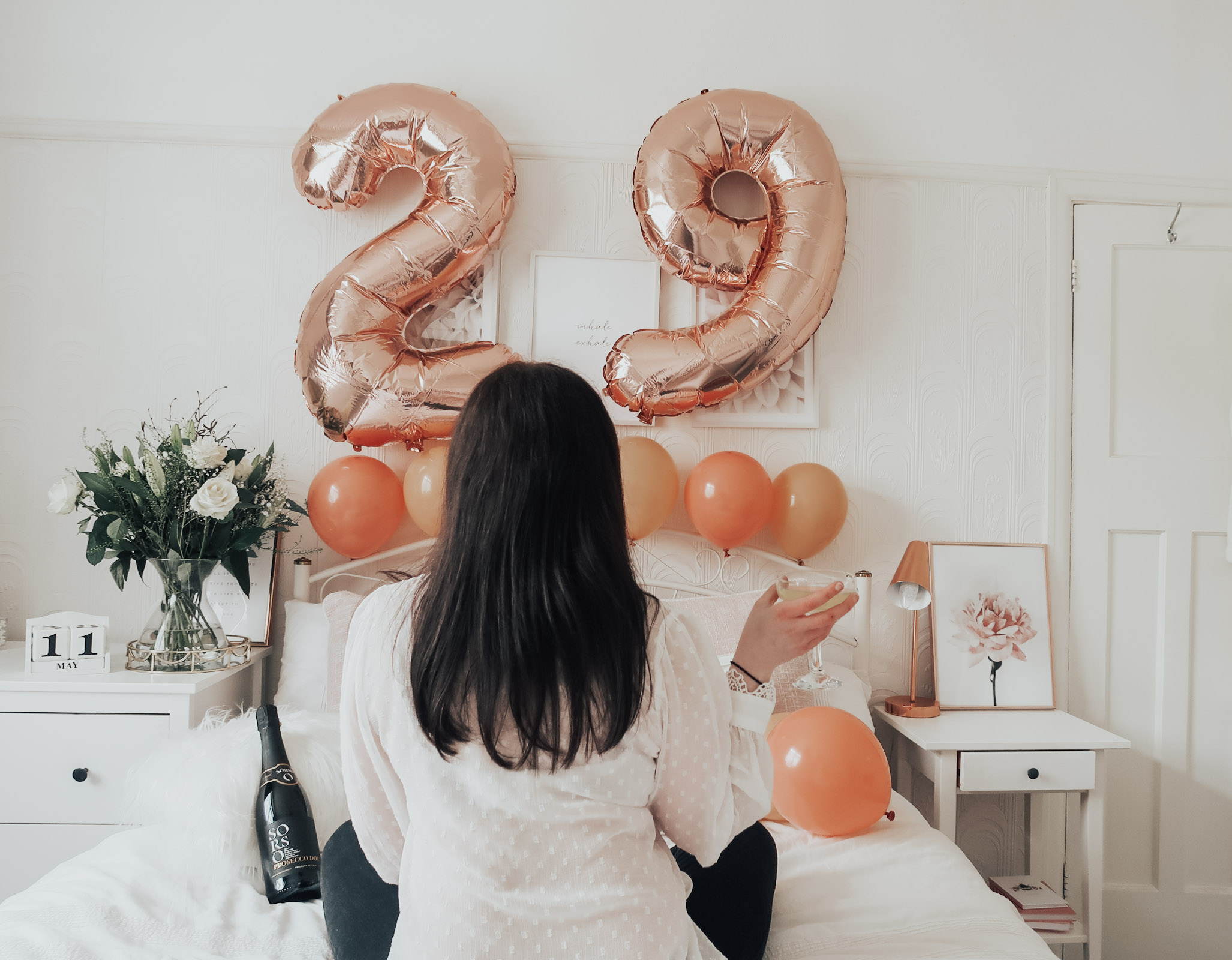 A woman with a 29 rose balloon