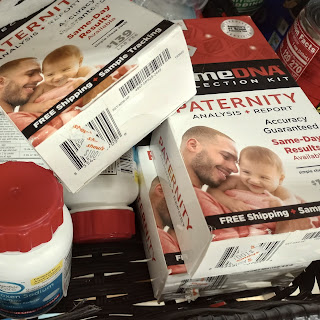 Haphazardly piled boxes labeled as home paternity test kits