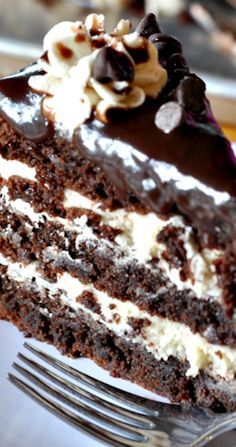 Rich and decadent, this three-layer brownie cake is filled with cookie dough frosting and topped with a silky chocolate ganache. Recipe source: Adapted from Life Love and Sugar