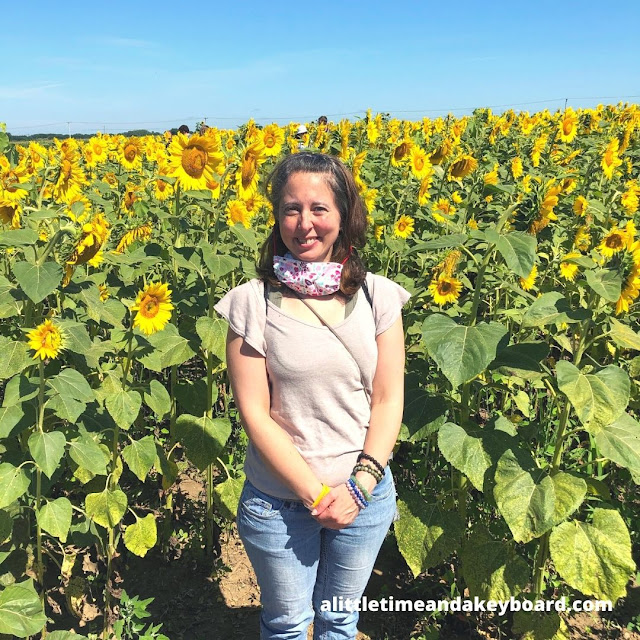 Standing near stunning sunflowers at Von Bergen's Sunflower Maze.