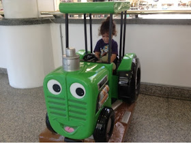 green tractor toy with toddler 