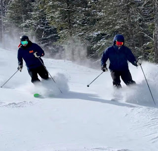 Skiers enjoying the fresh powder at Saddleback Maine Ski Resort