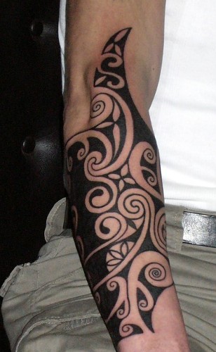 Large tribal tattoo on forearm.