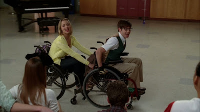 Quinn and Artie singing I'm Still Standing while rolling around in wheelchairs