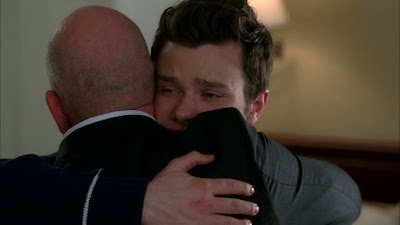 Burt giving Kurt a big hug. Kurt has tears in his eyes.