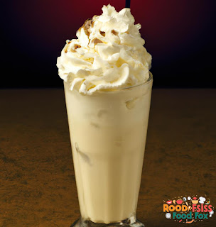 The third image shows the final product, a tall glass filled with a thick and creamy vanilla milkshake. The image also shows the whipped cream on top of the milkshake, which adds a nice touch to the presentation.