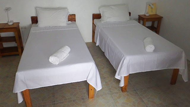 two beds and other amenities of a room at Sogod Bay Scuba Resort, Padre Burgos, Southern Leyte
