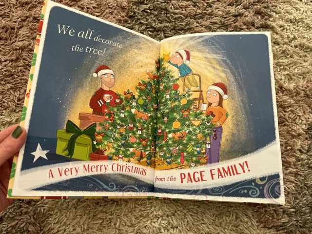 an open book with a christmas tree