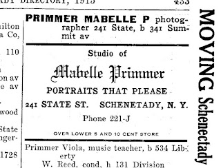 Directory entry reads "Primmer Mabelle P photographer 241 State, b 341 Summit av." Ad text reads "Studio of Mabelle Primmer Portraits that Please 241 State St. Schenectady NY Phone 221-J Over Lower 5 and 10 Cent Store"