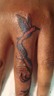 Humming bird finger tattoo
