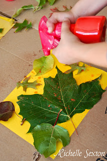 Spraying paint onto leaves and paper