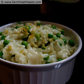 close up photo of a bowl of creamy lemon risotto with peas and parmesan