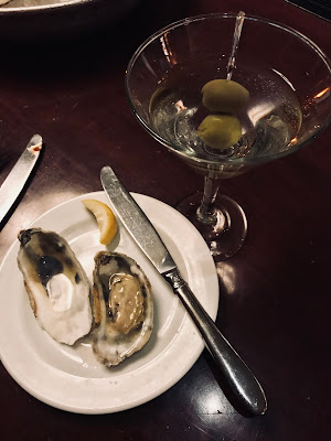 Photo of raw oysters on a plate with Martini