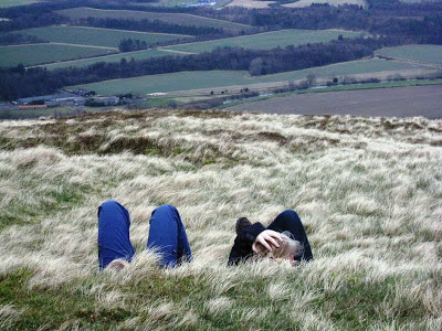 Teenagers lying at the top of the hill