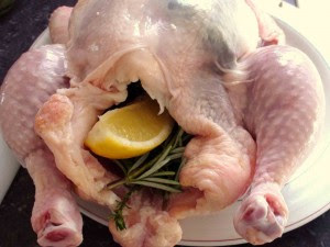 Lemon and herbs inside of chicken.