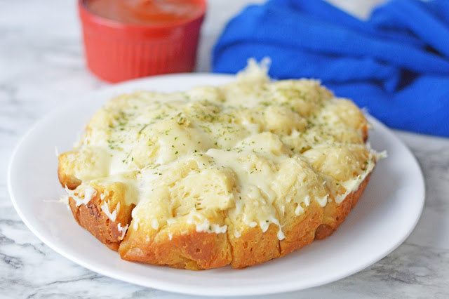 whole monkey bread sitting on a white plate.