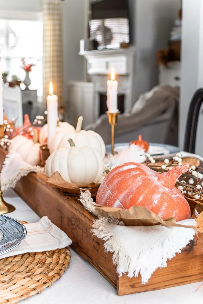 wood box filled with pumpkins, fall leaves