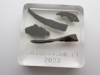 Resin paperweight containing pieces of Formula 1 tyre rubber