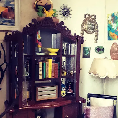 One-tweflth scale miniature witch's study with a cupboard full of magical items.