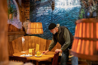 A worker clears a table at The Yellow Deli on Jan. 29, 2023.