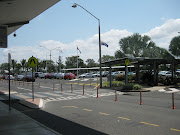 . cars that were parked along the road which leads to the airport. (img )