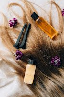 An image showcasing the application of a leave-in product to hair, providing extra moisture and nourishment for enhanced health and shine to make your hairstyle last longer.