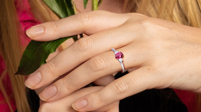 A person wearing a pink tourmaline ring