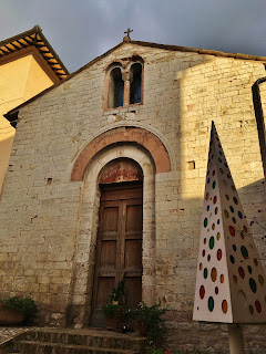 Ancient San Martino Church with modern Christmas tree in Spello, Umbria, Italy