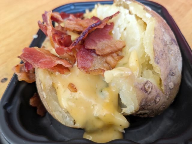 Side view of Wendy's Bacon Queso Baked Potato.