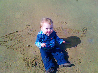 Angel wings drawn in sand a cute baby a photo to heart forever