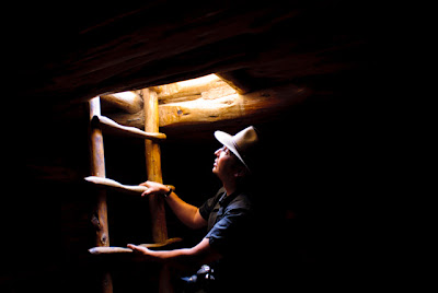 Daylight bathes Jeremy Wade Shockley as he climbs out of a kiva at Mesa Verde National Park. 