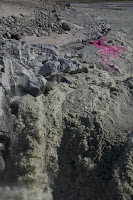 This photo shows a rhodamine dye injection into the proglacial river, just before a waterfall. The pink dye (the rhodamine) is used to calculate the water discharge of the proglacial river (i.e. how much water/melt if flowing in the river at that time). [Credit: Jakub D Zarsky] Click to Enlarge.