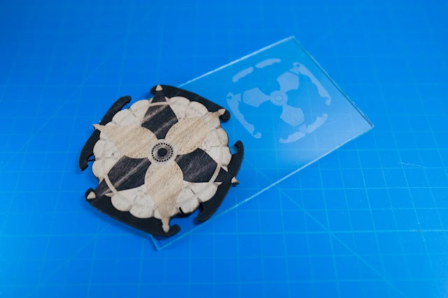 Laser cut design on wood and glass