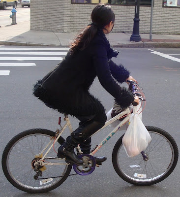 all black outfit on a bike