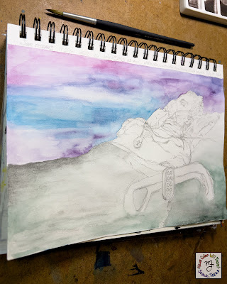 A pencil and watercolor wash illustration of a seriously ill young man lying in a hospital bed lies on a brown table. There is a paintbrush sitting just above the sketchbook.