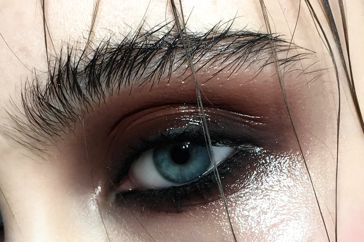 a close-up of a blue eye with a grunge smokey eye makeup look
