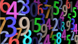 Lots of colorful numbers on a black background. Photo by fotoblend at https://pixabay.com/photos/pay-numbers-digits-mathematics-2662758/