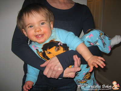 Baby with torticollis doing a strengthening exercise