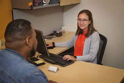 An undergraduate student working as front desk receptionist