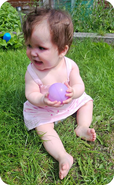 Baby girl playing in the sunshine